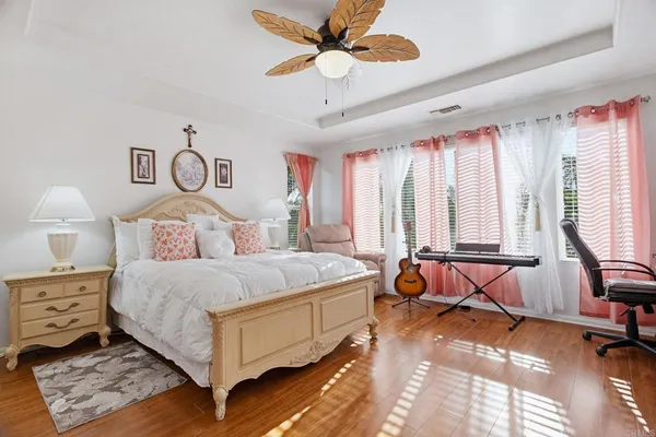 a bedroom with a bed and a chandelier