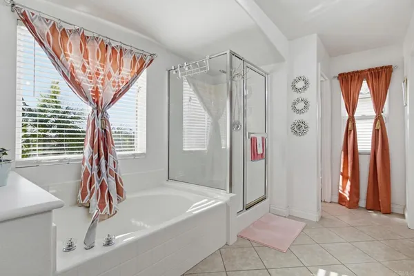 a bathroom with a bathtub and a shower