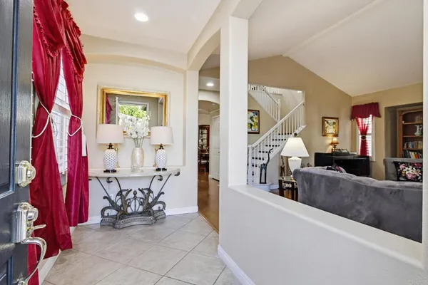 a view of living room kitchen and entryway