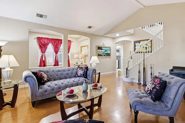 a living room with furniture and wooden floor