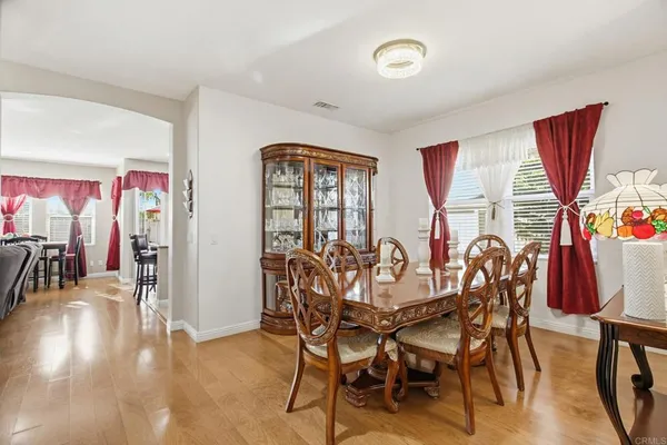 a view of a dining room with furniture window and wooden floor