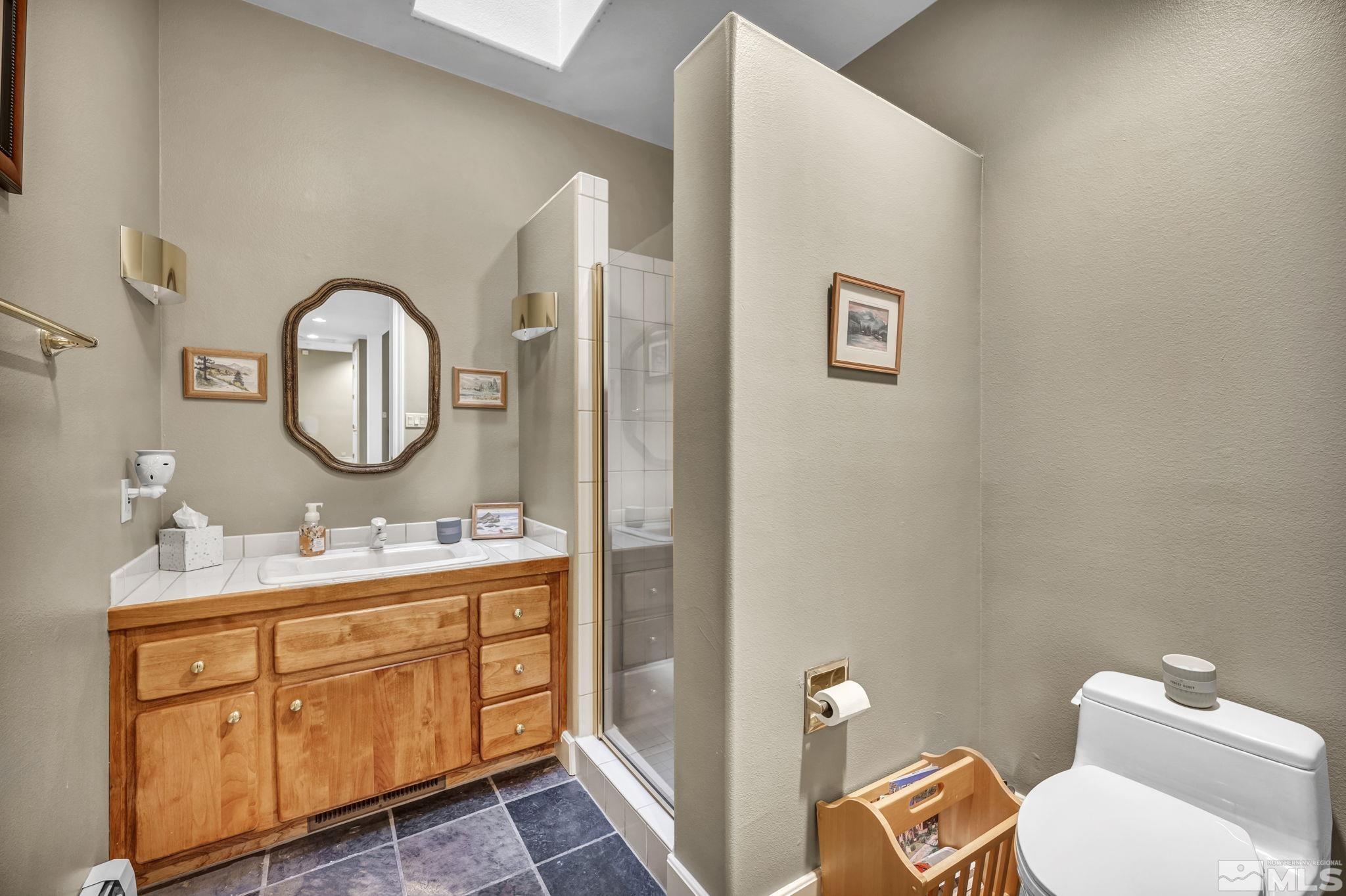 4277 Bitteroot Road Reno, NV 89519 - Photo 22 of 40 a bathroom with a toilet sink and mirror