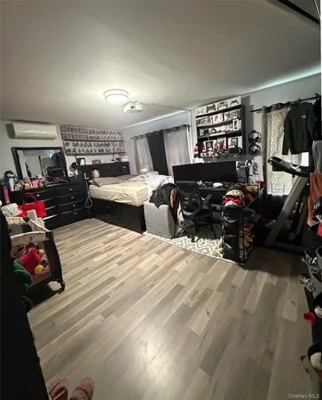 a bedroom with furniture and a wooden floor
