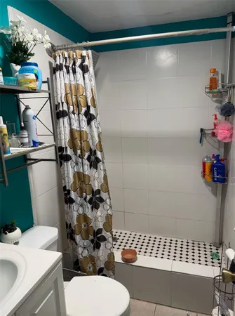 a bathroom with a sink toilet and shower