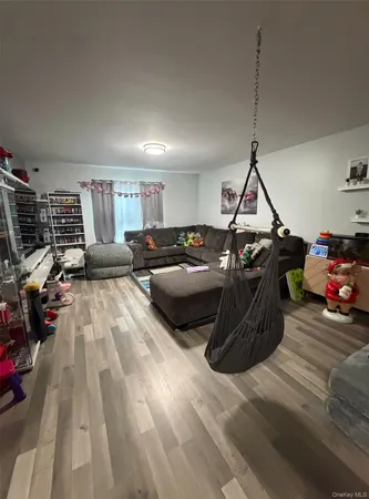 a bedroom with furniture and a wooden floor