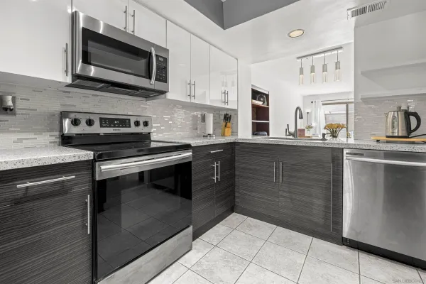 a kitchen with stainless steel appliances granite countertop a stove and a microwave