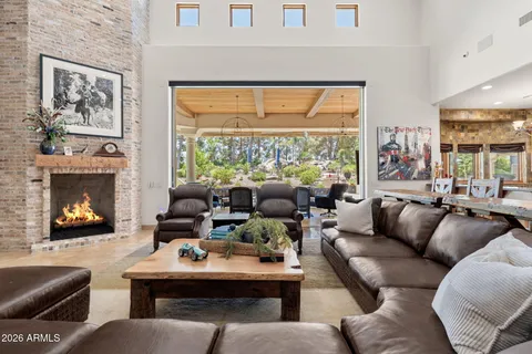 a kitchen with stainless steel appliances granite countertop a kitchen island a stove a table and chairs in it