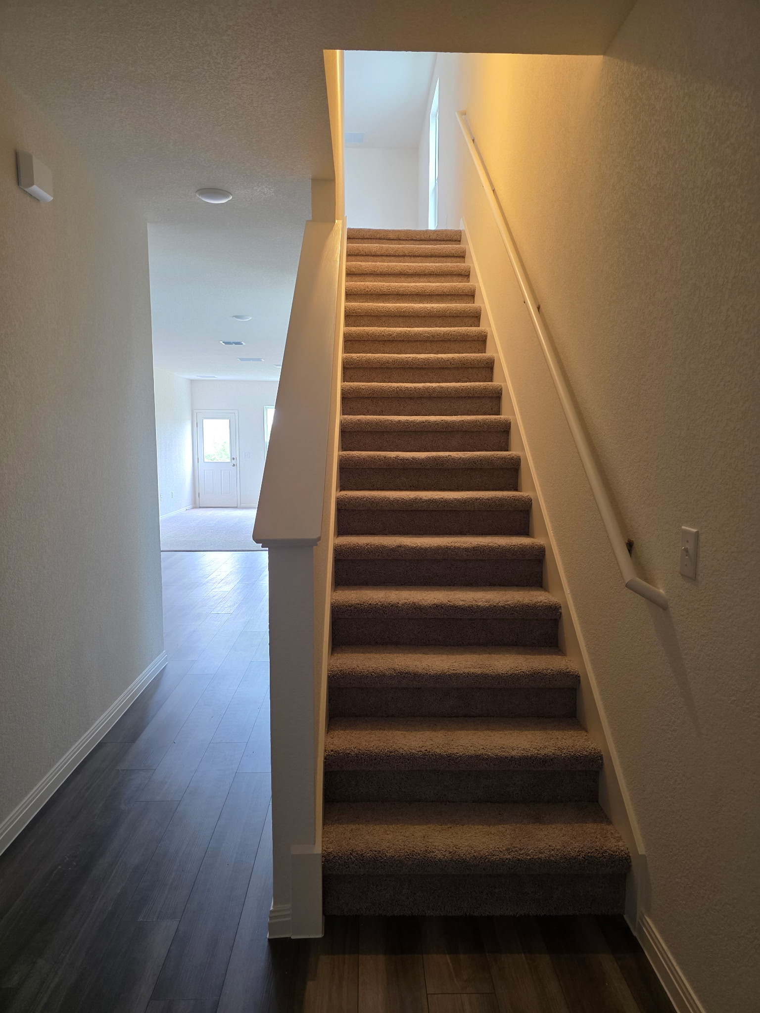 353 Enforcer Loop Jarrell, TX 76537 - Photo 6 of 21 Stairway with wood finished floors and baseboards