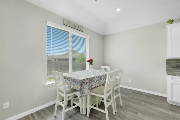 a view of a dining room with furniture and wooden floor