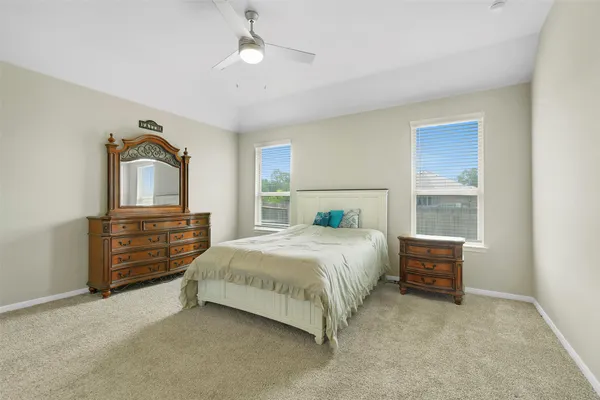 a bedroom with a bed and a dresser in it