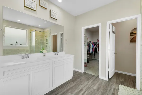 a spacious bathroom with a double vanity sink and a mirror