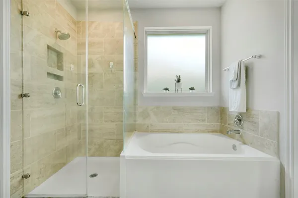 a bath tub sitting next to a shower