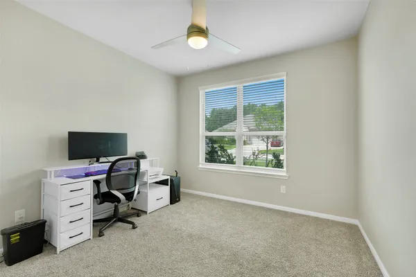 a livingroom with workspace and a window