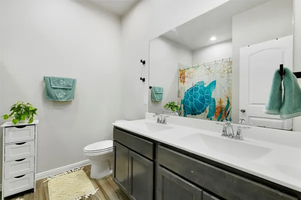a bathroom with a sink toilet and shower