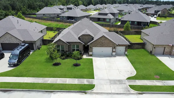 an aerial view of multiple houses with yard