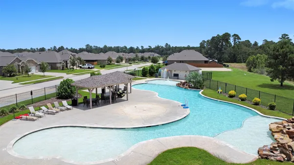 an aerial view of a house with outdoor space patio and lake view