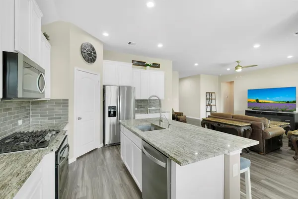 a kitchen with a stove a refrigerator and a sink