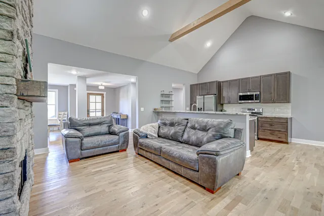 a bathroom with a granite countertop sink a large mirror and next to a window
