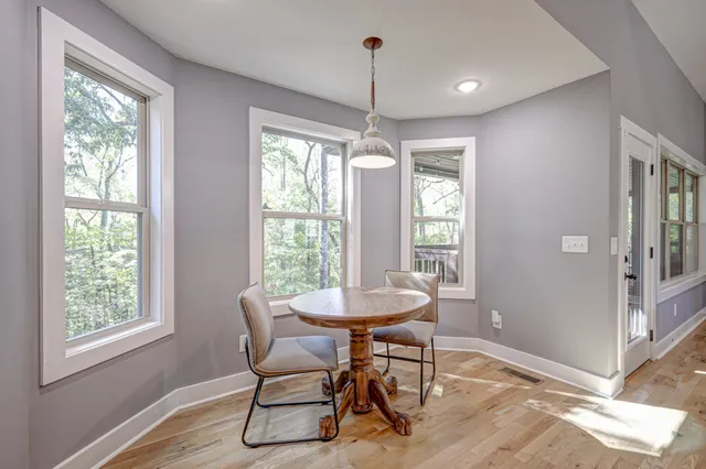 a view of a livingroom with furniture window and wooden floor