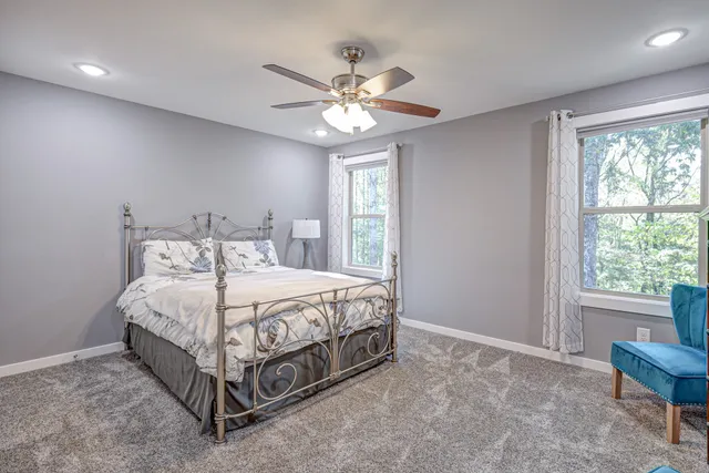 a view of a livingroom with a chandelier fan and a window