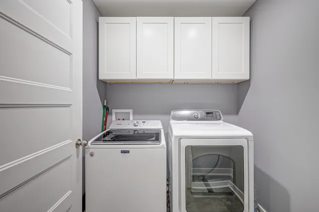a view of a house with backyard and trees
