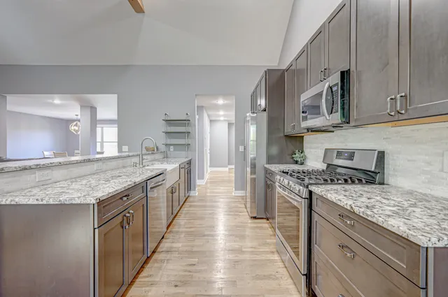 a large kitchen with a stove top oven