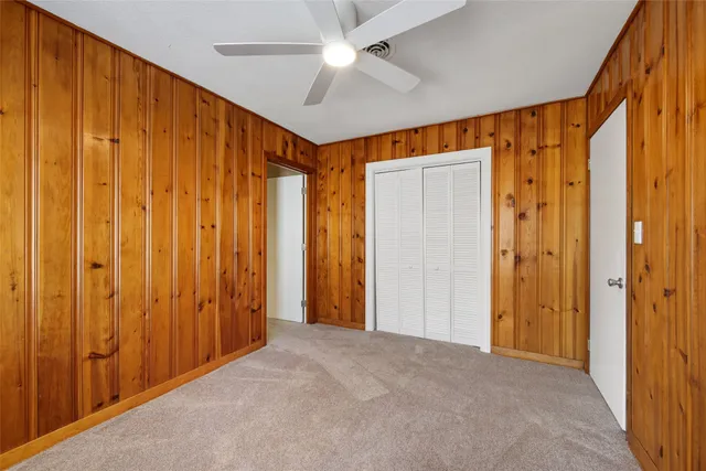a view of a hallway with a chandelier fan and stairs
