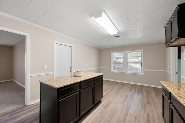 a bathroom with a granite countertop sink toilet a large mirror and a window