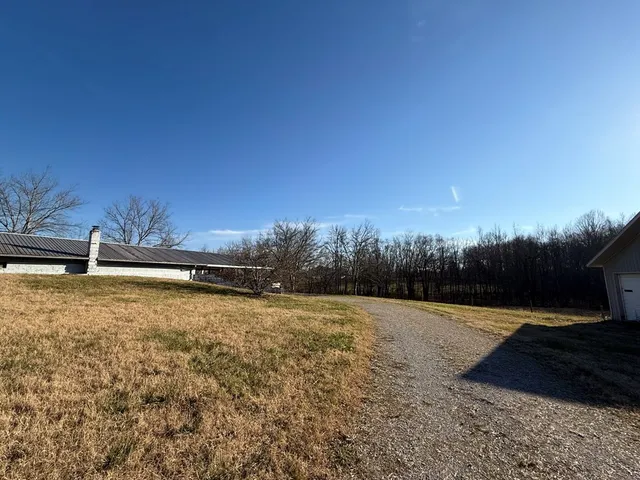 a backyard of a house with lots of green space