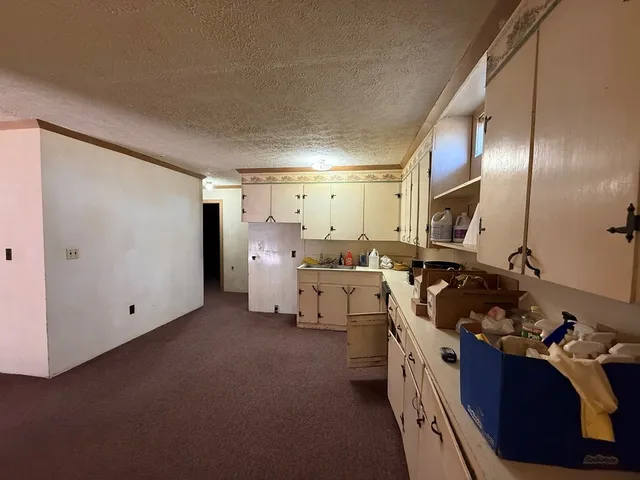 an empty room with a ceiling fan and a window