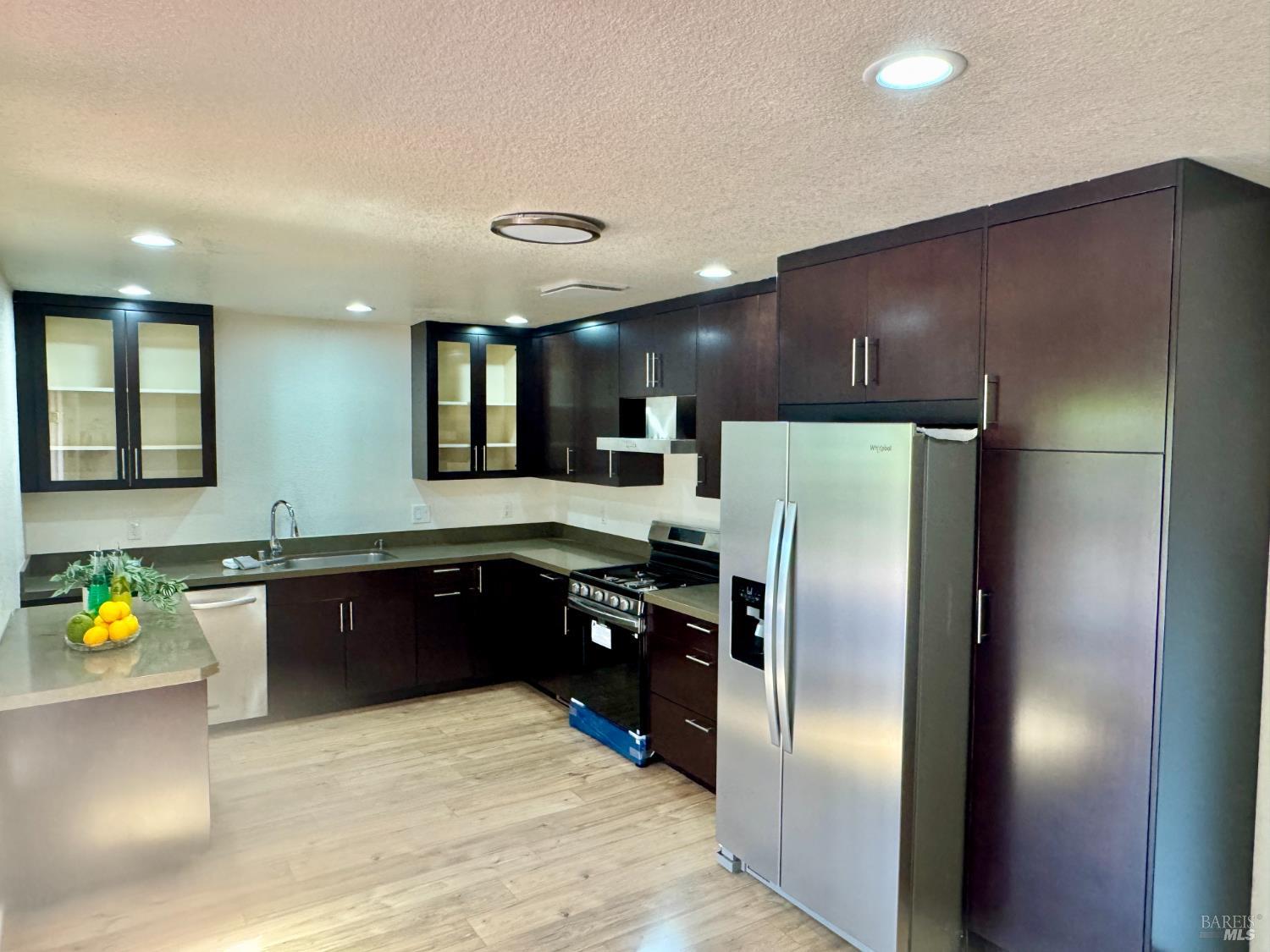 1836 Hearn Avenue Santa Rosa, CA 95407 - Photo 6 of 22 a large kitchen with stainless steel appliances granite countertop a refrigerator a stove and a sink