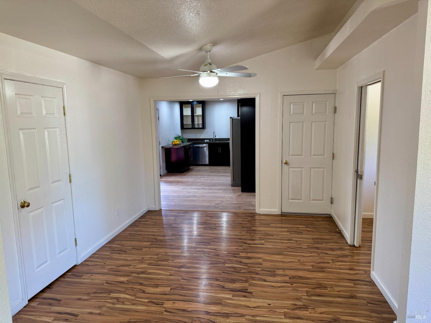 1836 Hearn Avenue Santa Rosa, CA 95407 - Photo 8 of 22 a view of a hallway with wooden floor and a living room