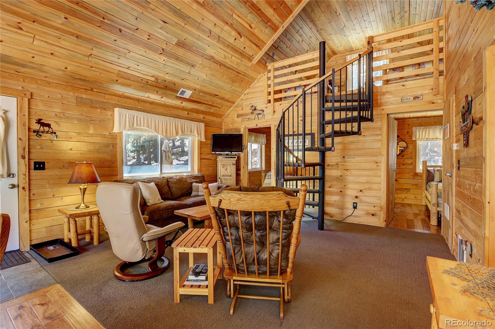 7721 County Road 43 Bailey, CO 80421 - Photo 19 of 49 a living room with furniture a air conditioner vent and a window