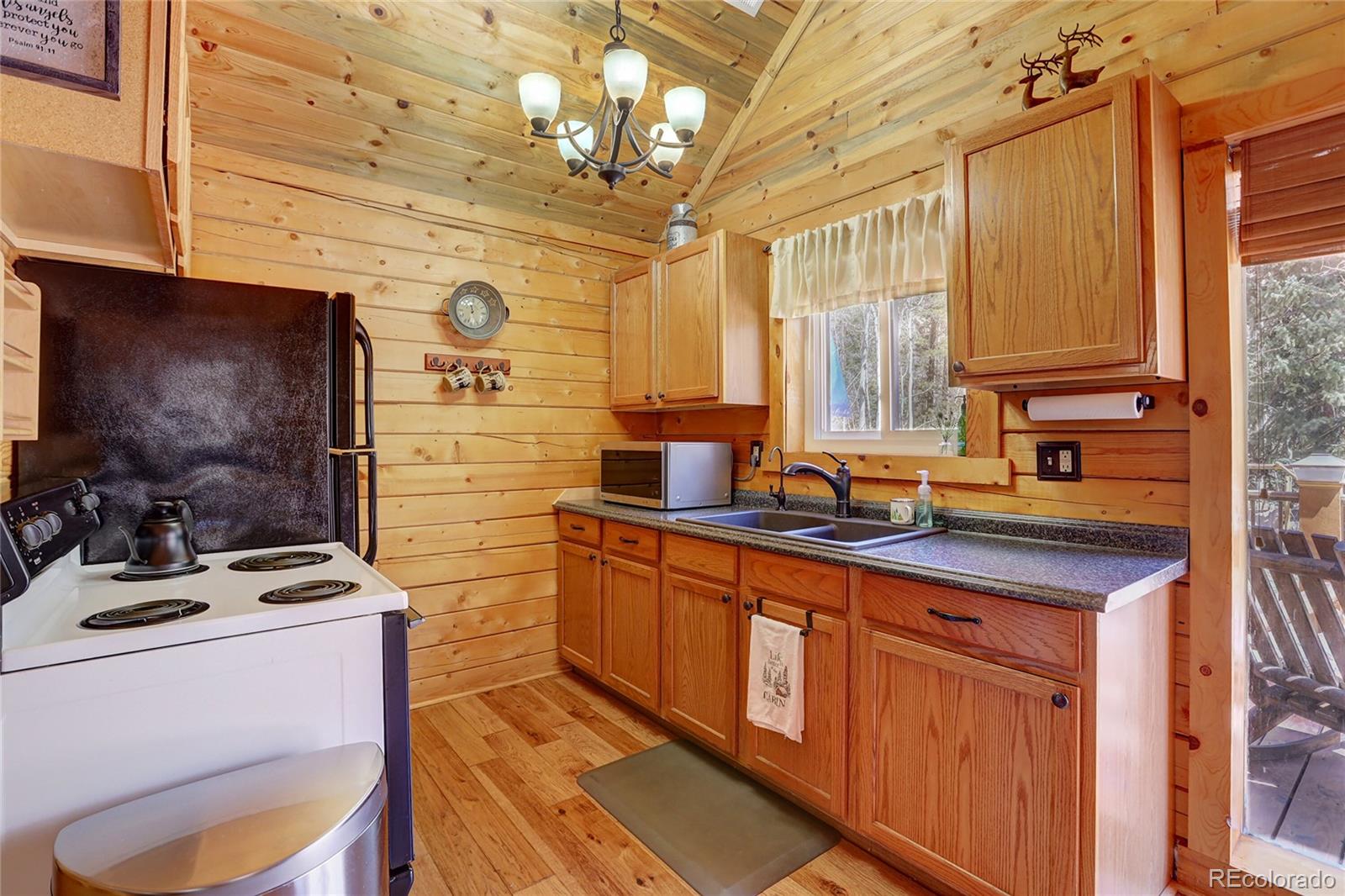 7721 County Road 43 Bailey, CO 80421 - Photo 25 of 49 a kitchen with stainless steel appliances a sink stove and cabinets