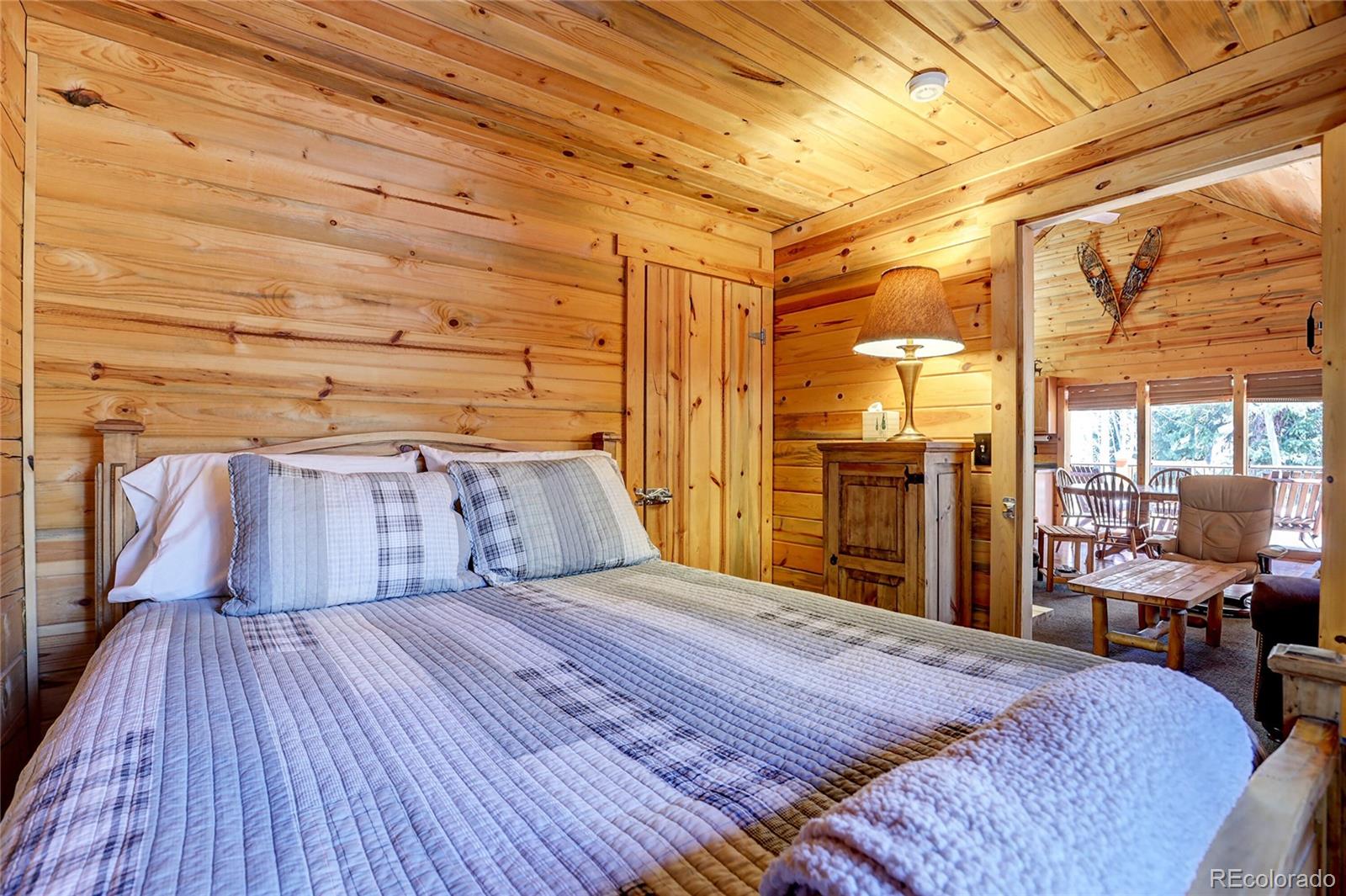 7721 County Road 43 Bailey, CO 80421 - Photo 35 of 49 a bedroom with a bed and large window with balcony view