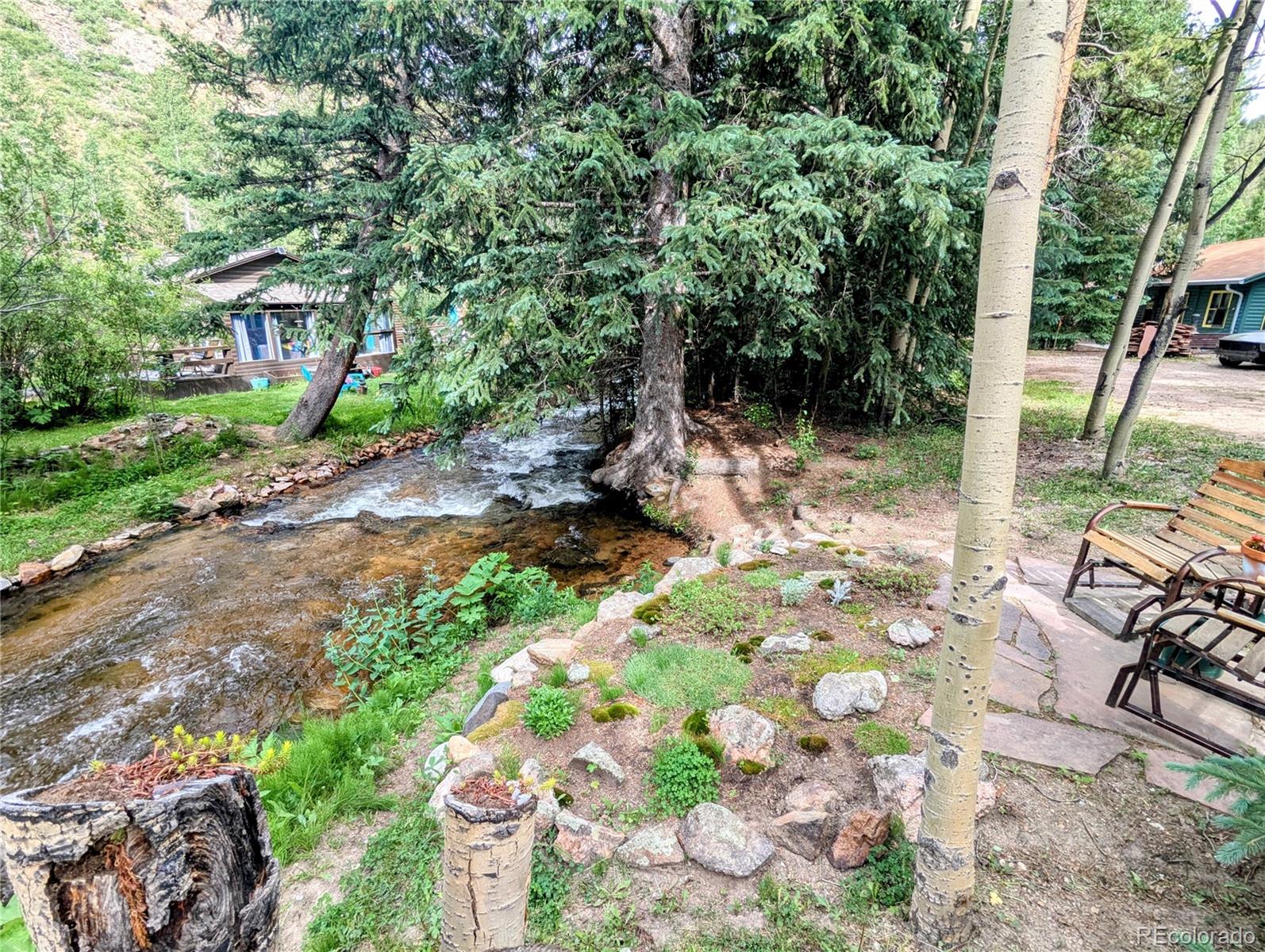 7721 County Road 43 Bailey, CO 80421 - Photo 4 of 49 a view of a chairs and table in backyard