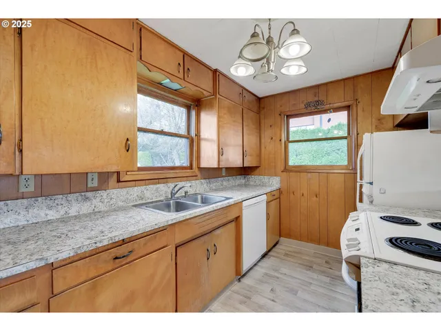 a kitchen with a sink appliances and cabinets