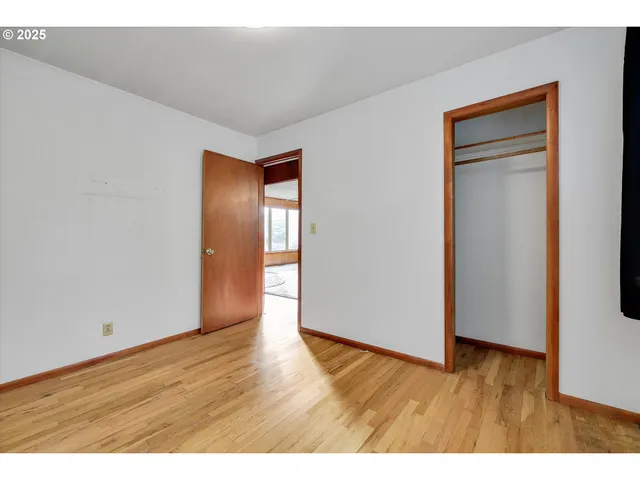 a view of an empty room and wooden floor