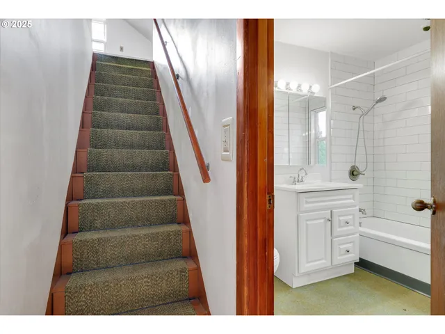 a bathroom with a tub shower vanity and a sink