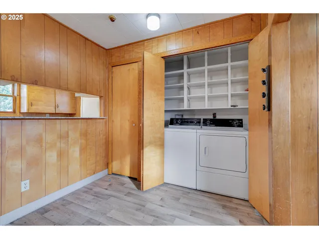 a view of kitchen with white cabinets and black appliances