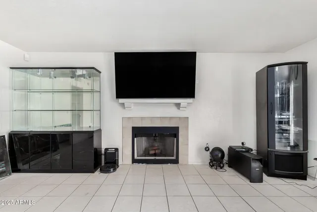 a living room with a fireplace and a flat screen tv