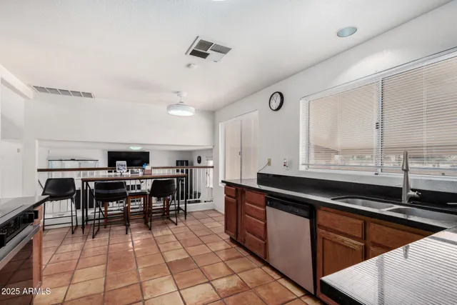 a kitchen with stainless steel appliances kitchen island granite countertop a sink and cabinets