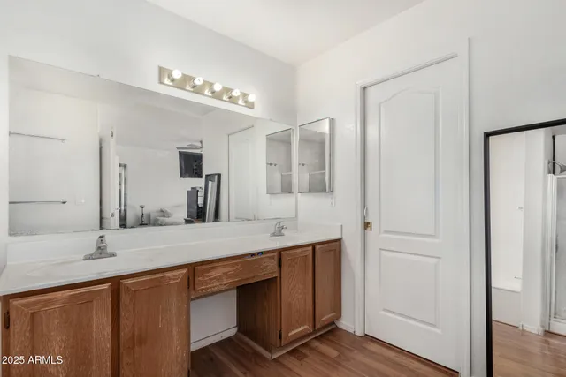 a bathroom with a double vanity sink and a mirror