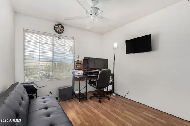 a livingroom with workspace and a window