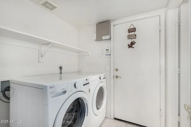 a view of storage and utility room with washer and dryer