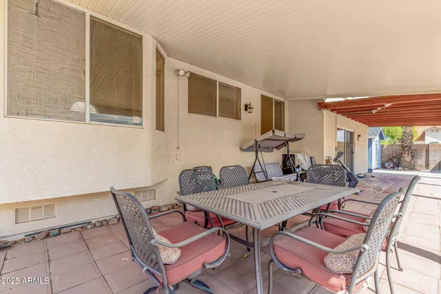 a view of a patio with table and chairs
