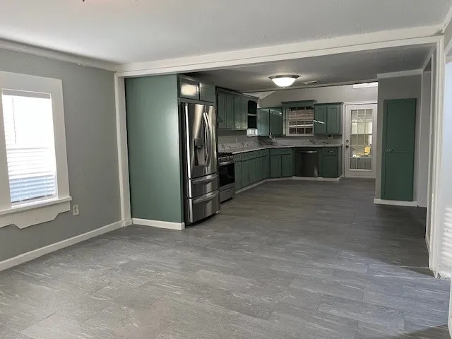 a view of kitchen with refrigerator and window