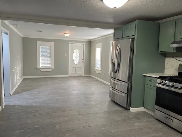 a view of kitchen with a refrigerator cabinets and a sink