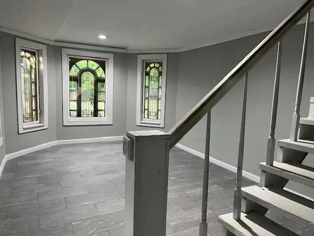 a view of an entryway with wooden floor windows and a chandelier