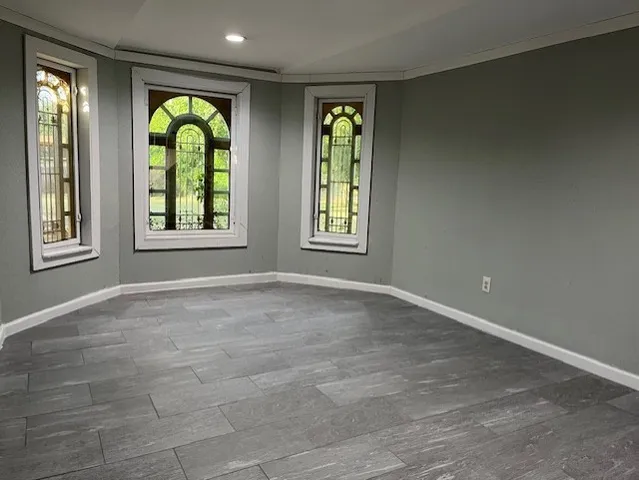 an empty room with windows and natural light